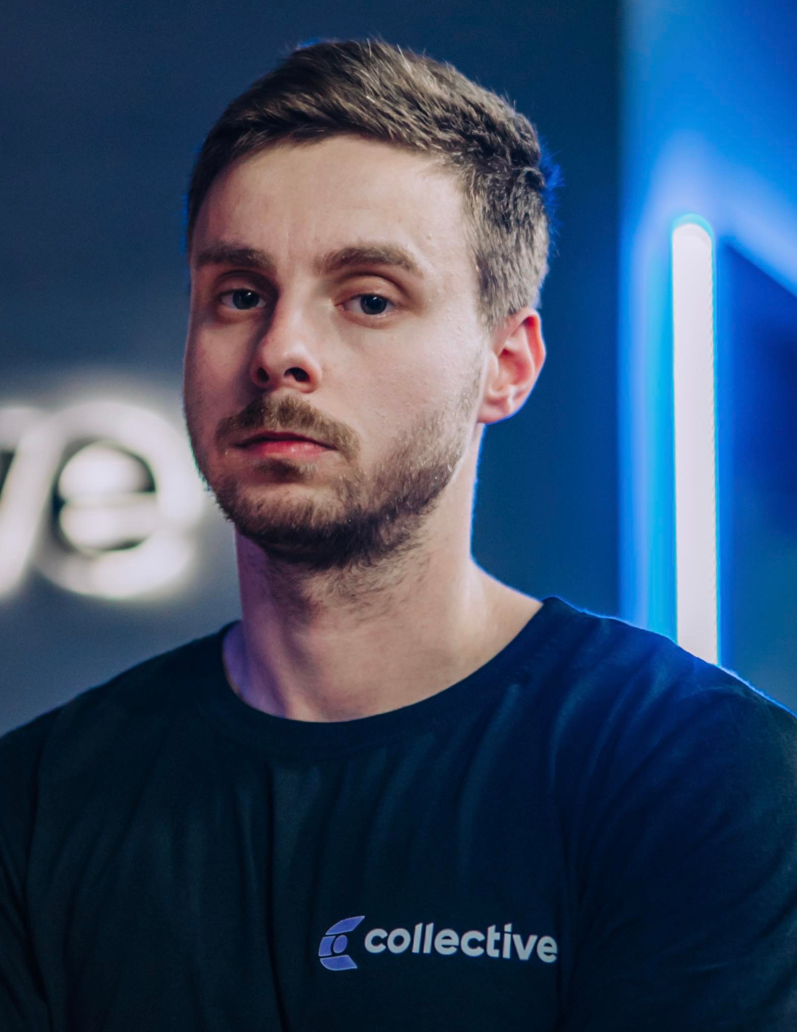 Muscular male trainer lifting weights in a gym